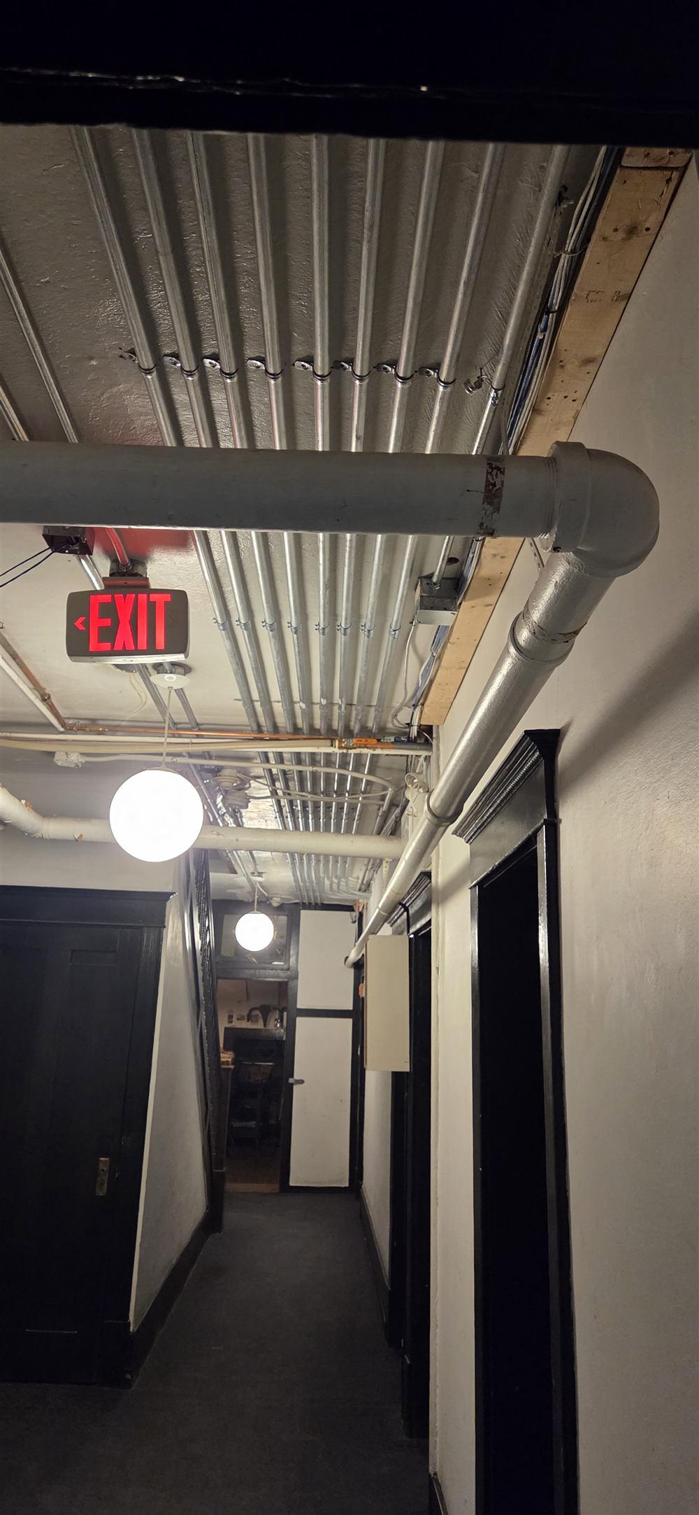 EMT conduit runs for suite feeders along a corridor ceiling