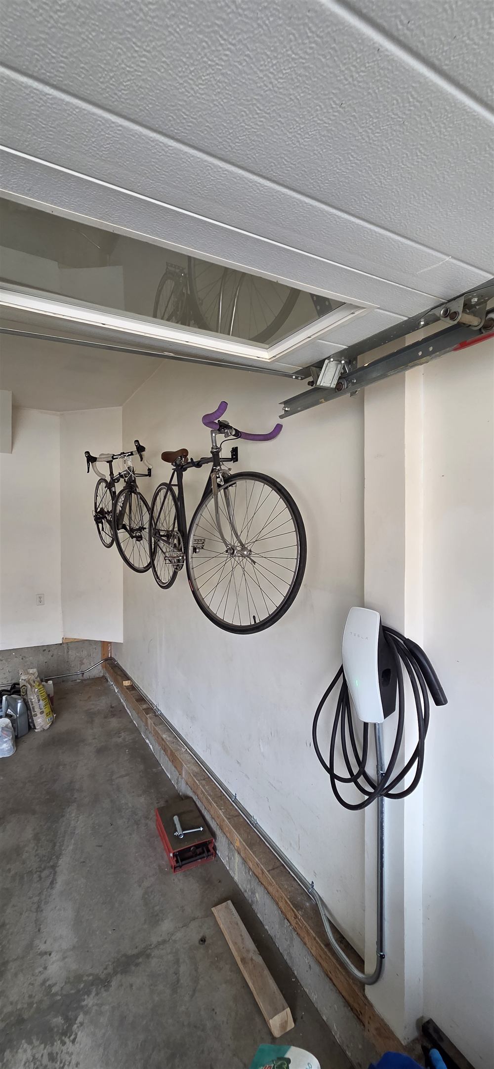 EV charger mounted in a garage with conduit run